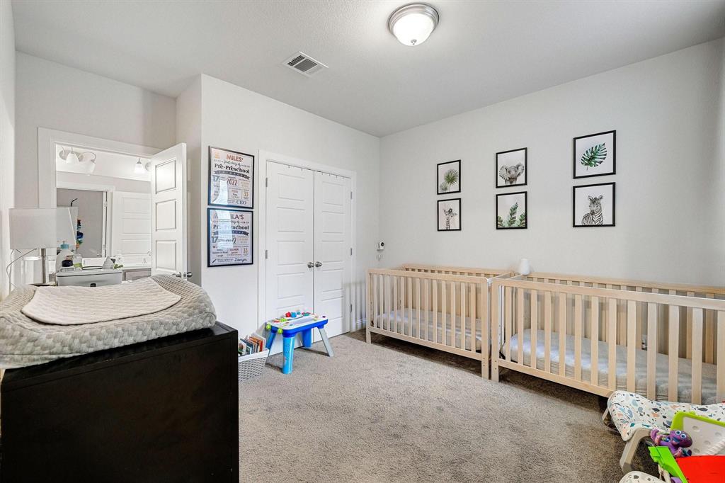 648 Aspen Valley Lane Dallas, TX 75208 - Photo 27 of 38 a bedroom with a bed and a table