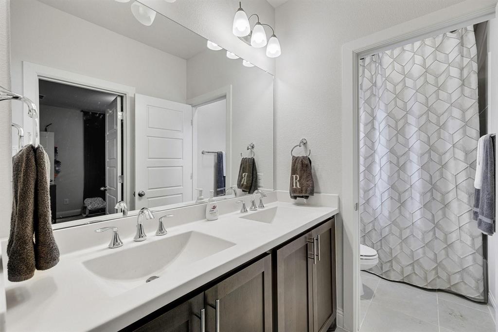 648 Aspen Valley Lane Dallas, TX 75208 - Photo 28 of 38 a bathroom with a sink vanity and a mirror