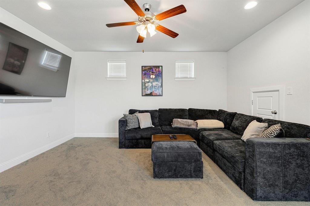 648 Aspen Valley Lane Dallas, TX 75208 - Photo 35 of 38 a living room with furniture and a flat screen tv