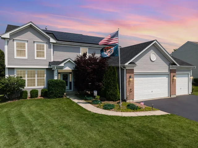 a front view of a house with a yard and garage