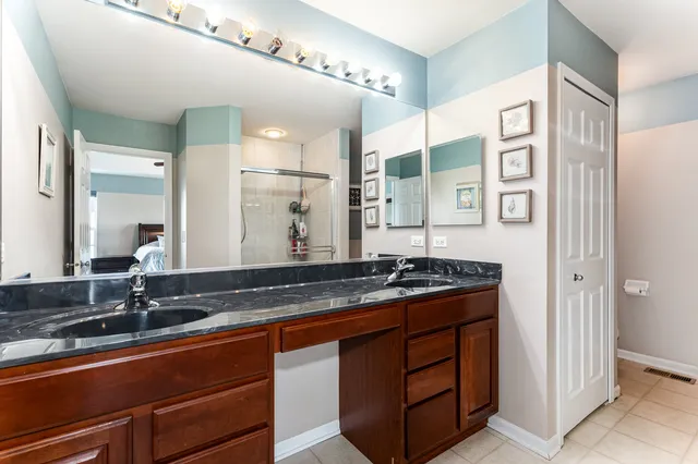 a bathroom with a granite countertop sink and a mirror