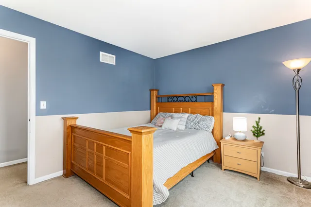 a bedroom with a bed and a night stand