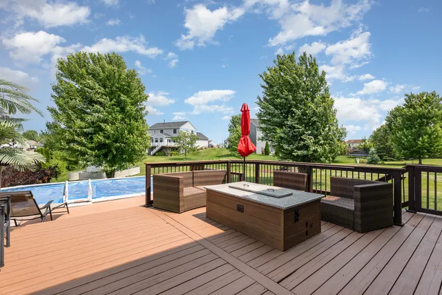 a view of a balcony with wooden floor and outdoor seating