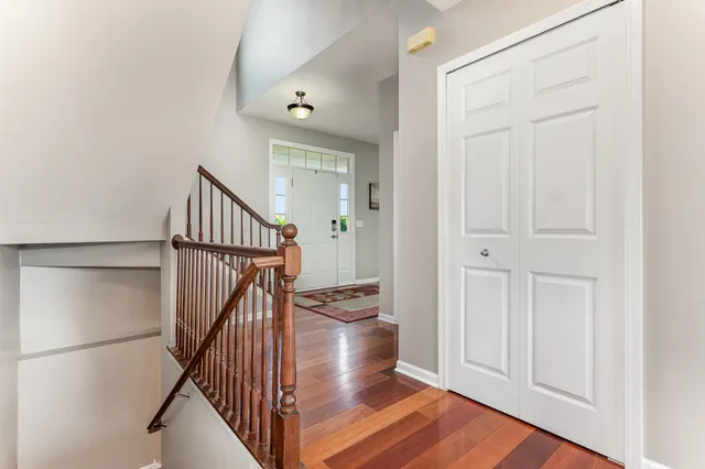 a view of entryway and hall with wooden floor