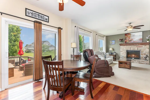 a dining room with furniture window and wooden floor