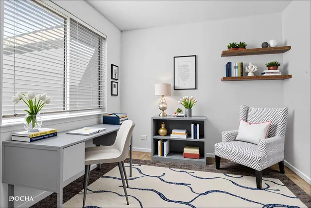 a work room with furniture and a potted plant
