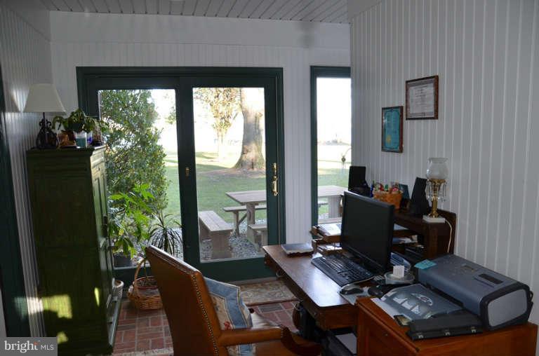 7891 Fuller Road St. Michaels, MD 21663 - Photo 12 of 23 a view of a workspace with furniture and a window