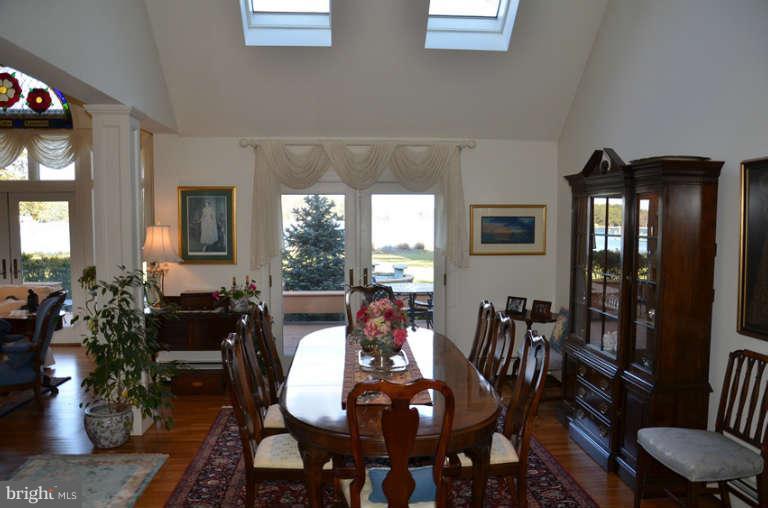 7891 Fuller Road St. Michaels, MD 21663 - Photo 16 of 23 a view of a dining room with furniture and wooden floor