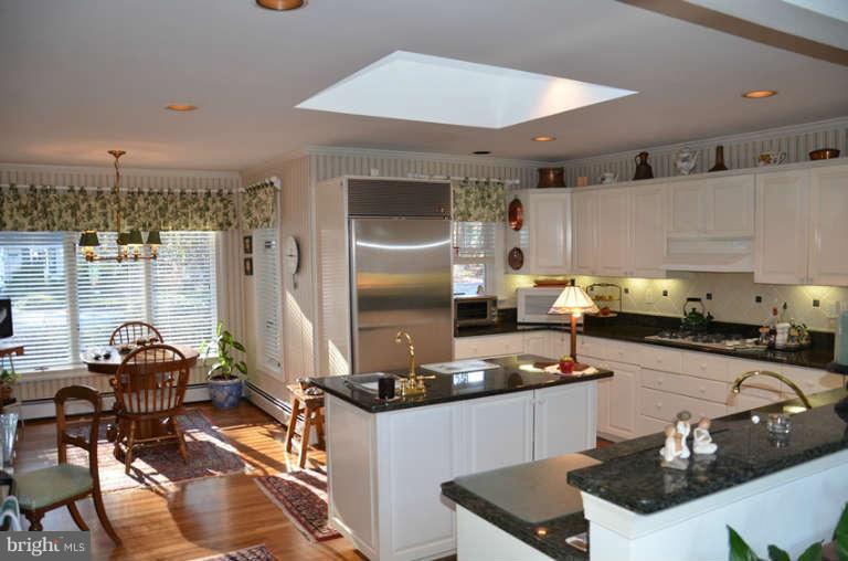 7891 Fuller Road St. Michaels, MD 21663 - Photo 18 of 23 a kitchen with stainless steel appliances granite countertop a sink stove and refrigerator