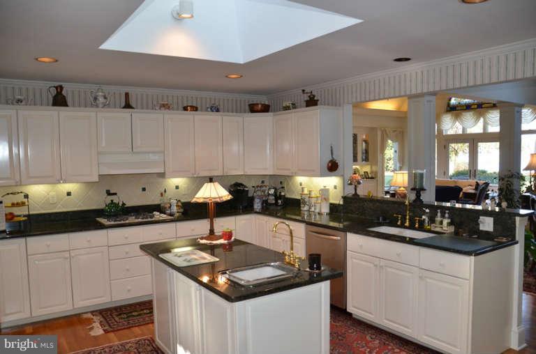 7891 Fuller Road St. Michaels, MD 21663 - Photo 19 of 23 a kitchen with granite countertop a sink a stove and cabinets