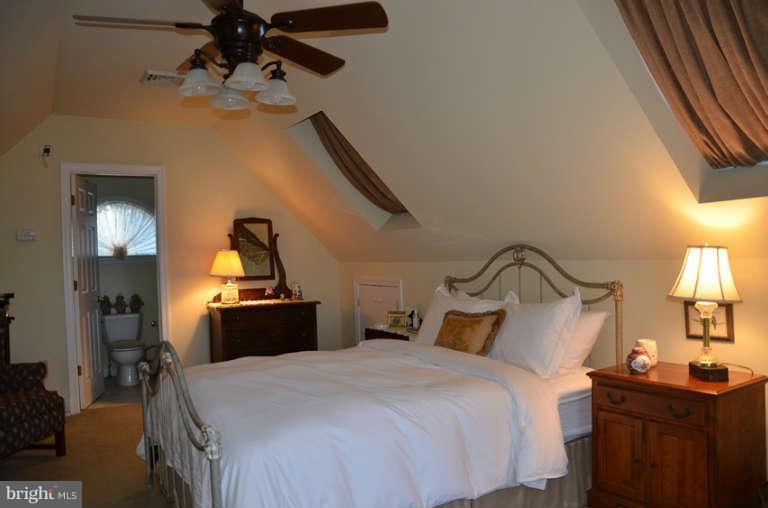 7891 Fuller Road St. Michaels, MD 21663 - Photo 21 of 23 a bedroom with a bed and a chandelier