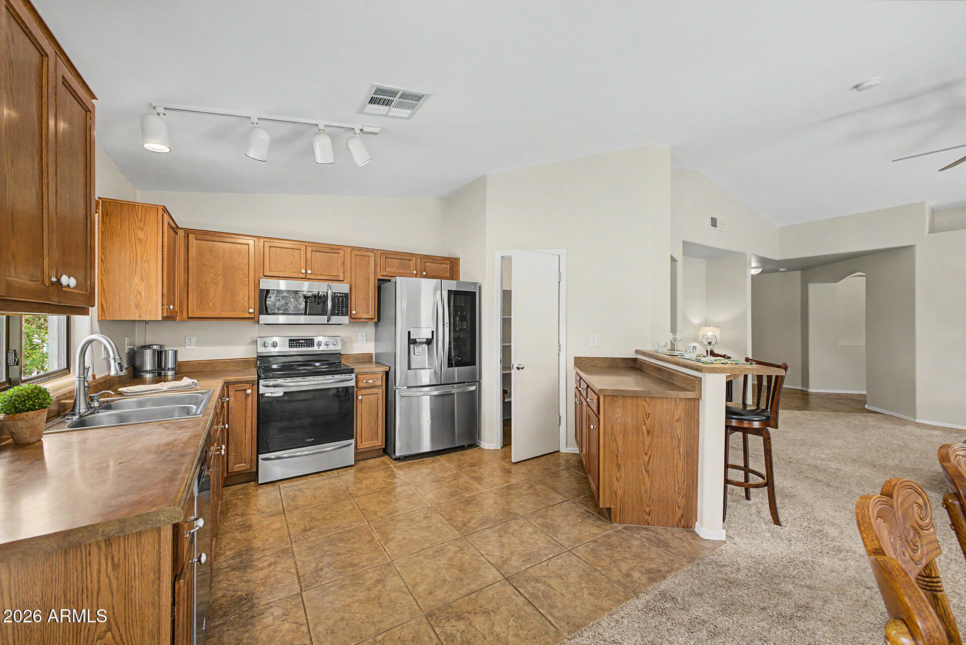 2101 South Meridian Road, Unit 133 Apache Junction, AZ 85120 - Photo 14 of 51 a kitchen with stainless steel appliances a refrigerator and a stove top oven