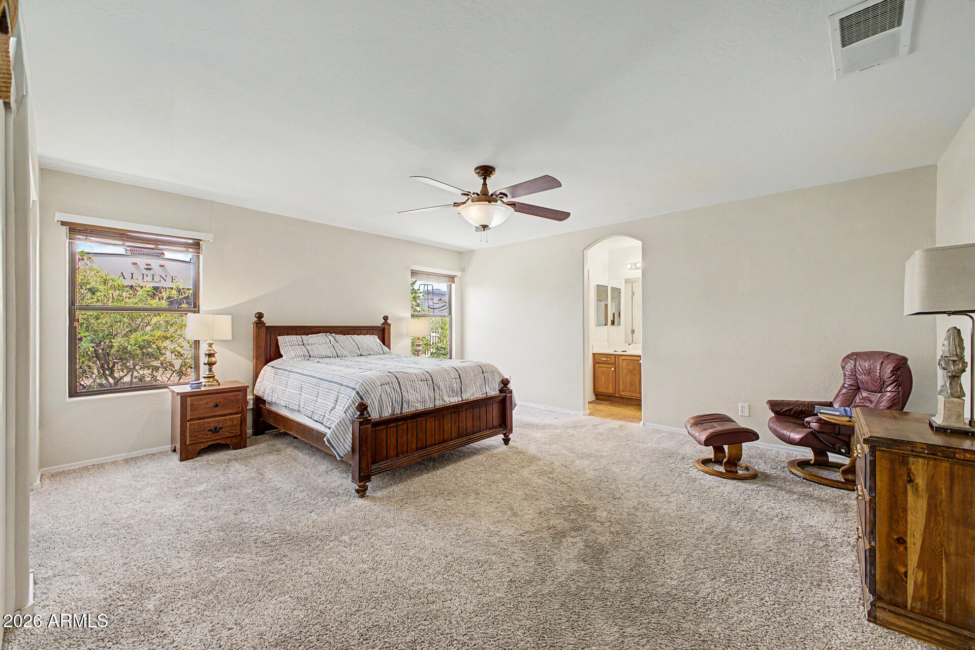 2101 South Meridian Road, Unit 133 Apache Junction, AZ 85120 - Photo 18 of 51 a bedroom with a bed and a chandelier