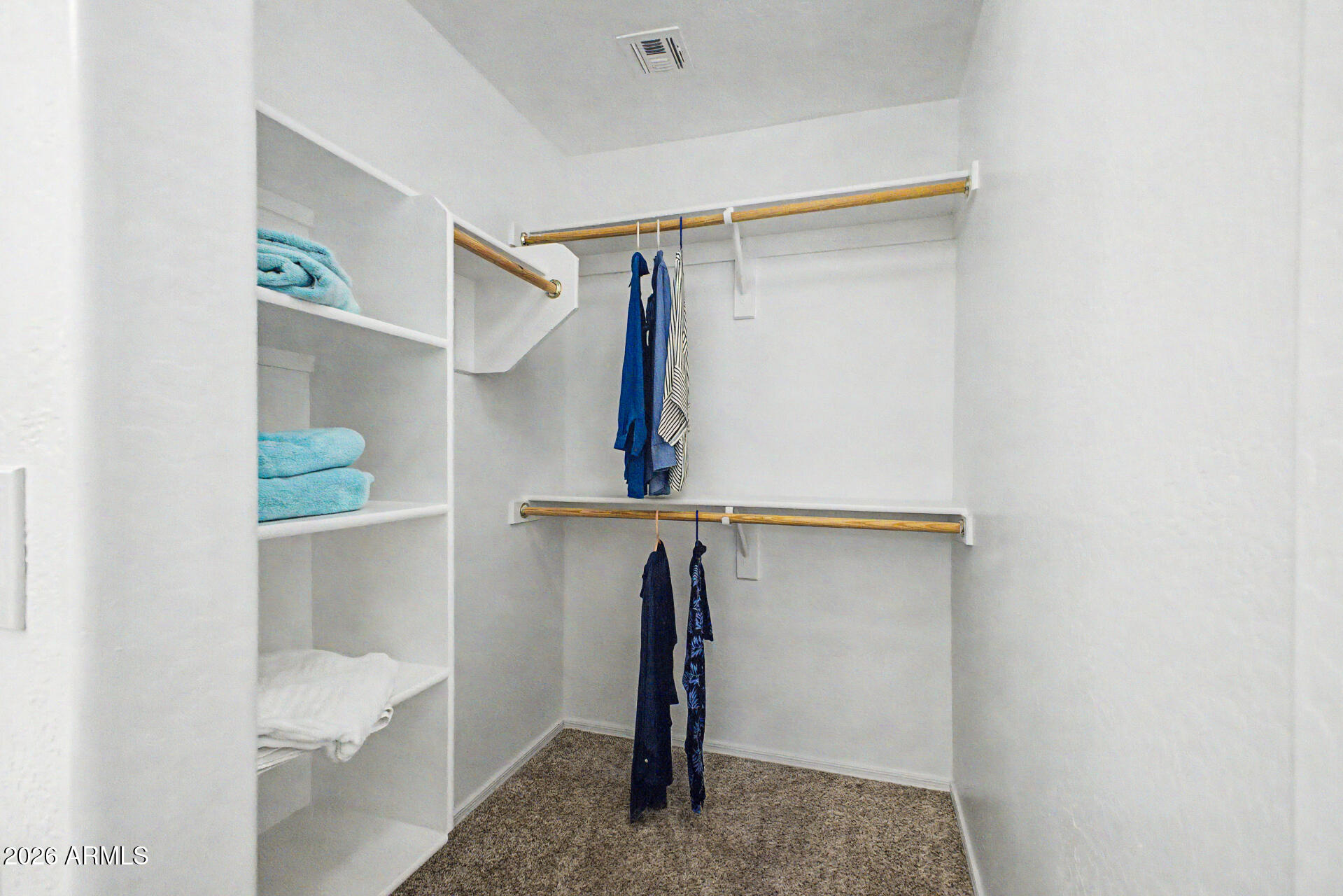 2101 South Meridian Road, Unit 133 Apache Junction, AZ 85120 - Photo 23 of 51 a view of walk in closet with clothes and shoes