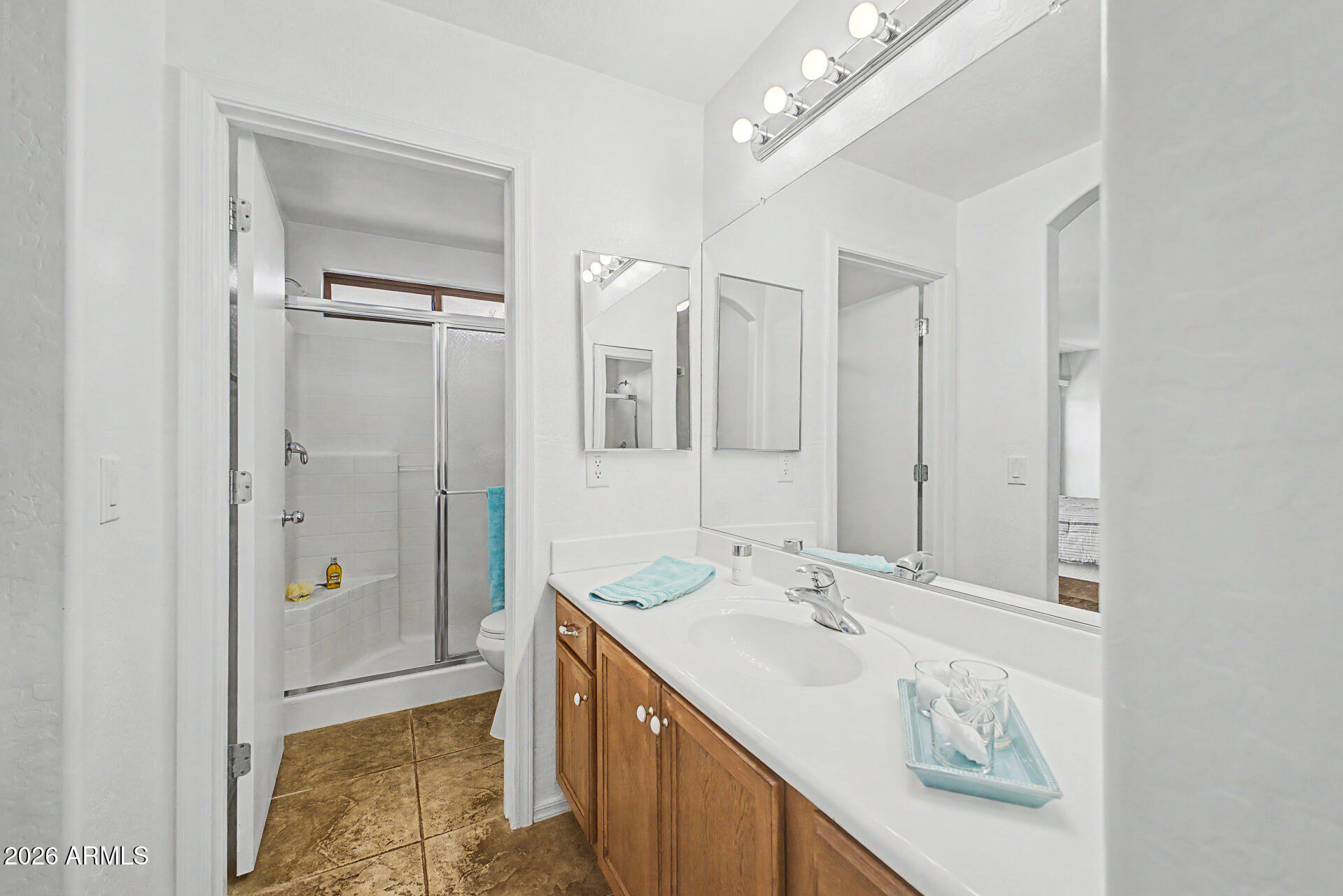 2101 South Meridian Road, Unit 133 Apache Junction, AZ 85120 - Photo 24 of 51 a bathroom with a double vanity sink a mirror and a shower
