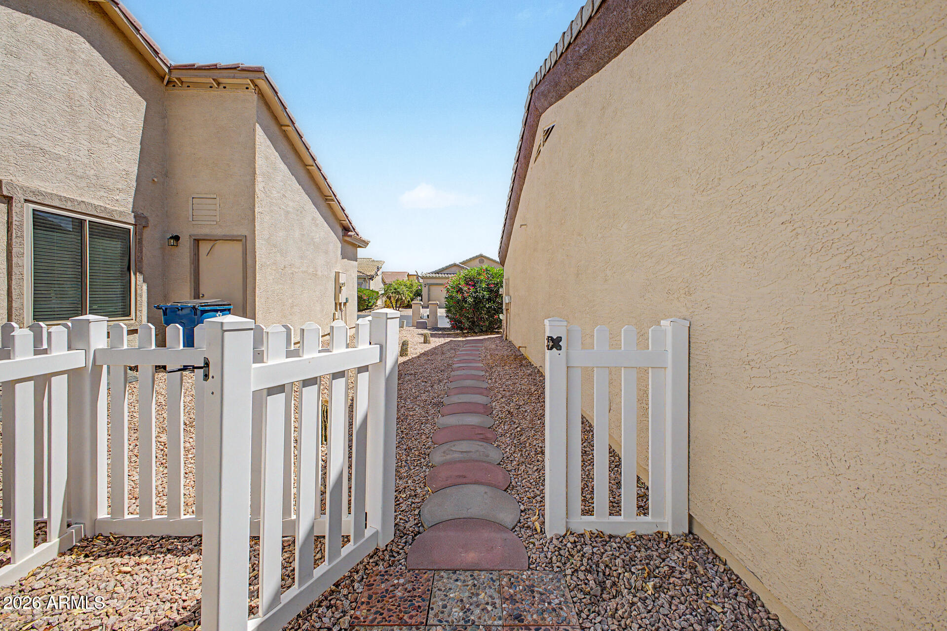 2101 South Meridian Road, Unit 133 Apache Junction, AZ 85120 - Photo 38 of 51 a view of a house with a small yard and wooden floor and fence
