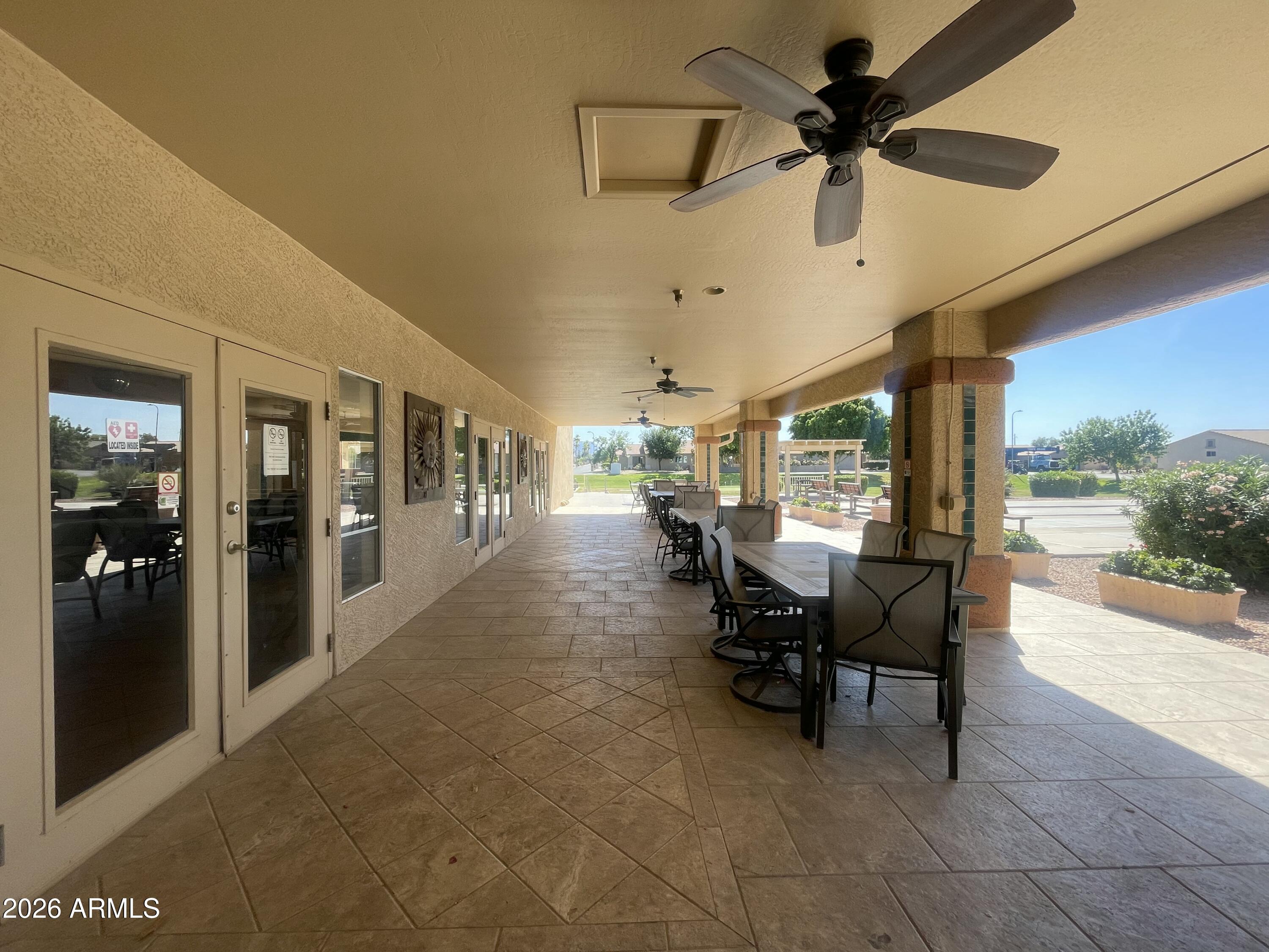 2101 South Meridian Road, Unit 133 Apache Junction, AZ 85120 - Photo 45 of 51 a dining room with furniture and a floor to ceiling window