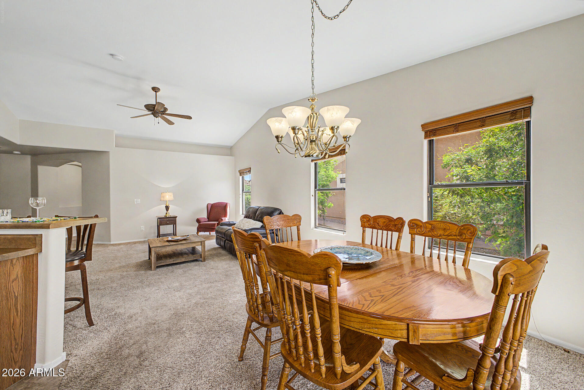 2101 South Meridian Road, Unit 133 Apache Junction, AZ 85120 - Photo 9 of 51 a view of a dining room with furniture a chandelier and wooden floor