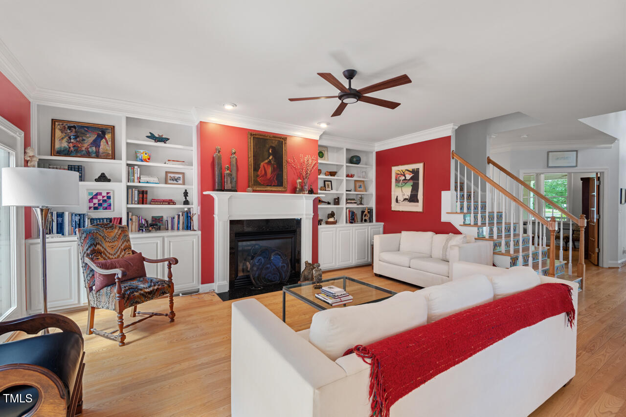 30119 Settle Chapel Hill, NC 27517 - Photo 14 of 49 a living room with furniture a fireplace and a book shelf