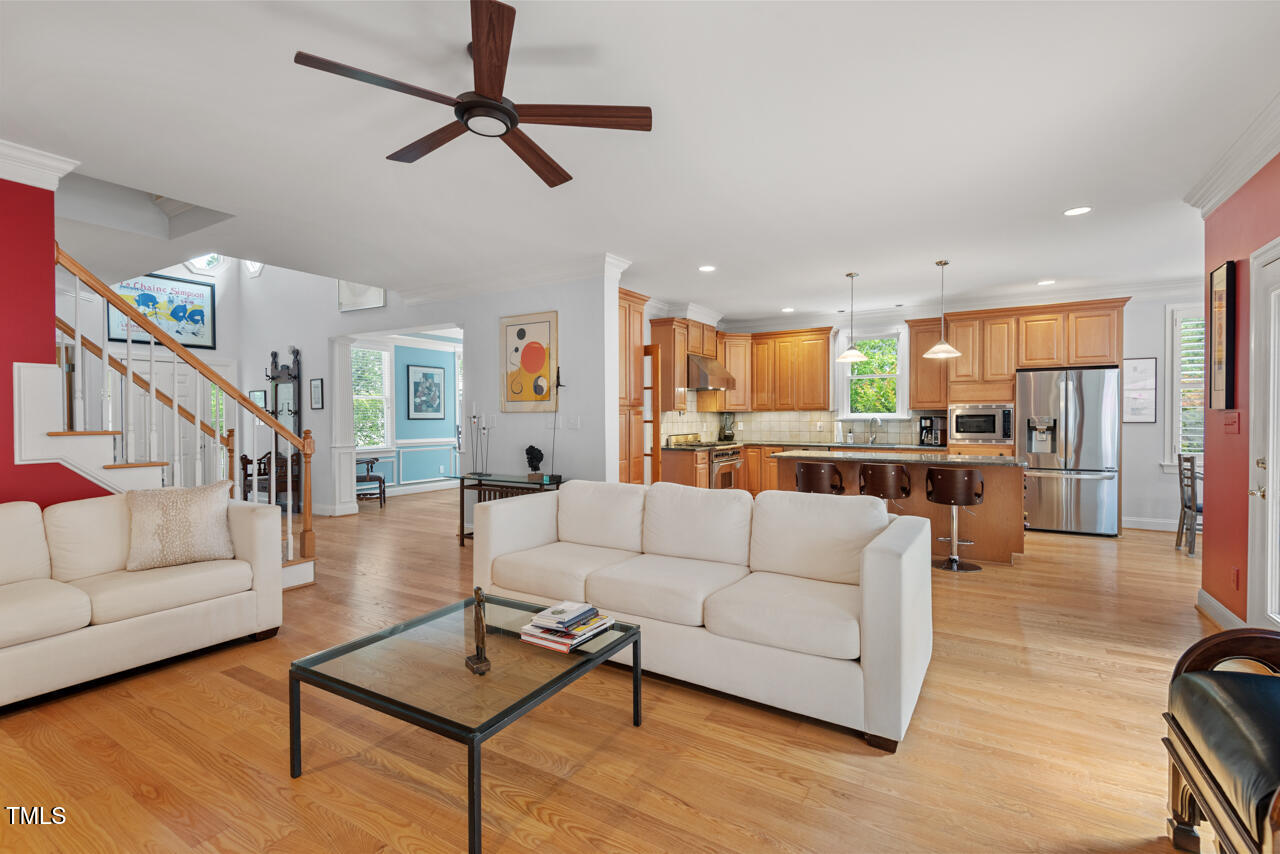 30119 Settle Chapel Hill, NC 27517 - Photo 16 of 49 a living room with furniture kitchen view and a wooden floor