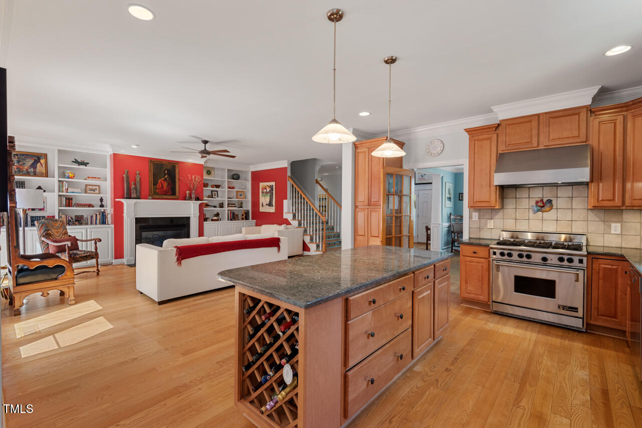 30119 Settle Chapel Hill, NC 27517 - Photo 20 of 49 a kitchen with stainless steel appliances granite countertop a stove and a wooden floors