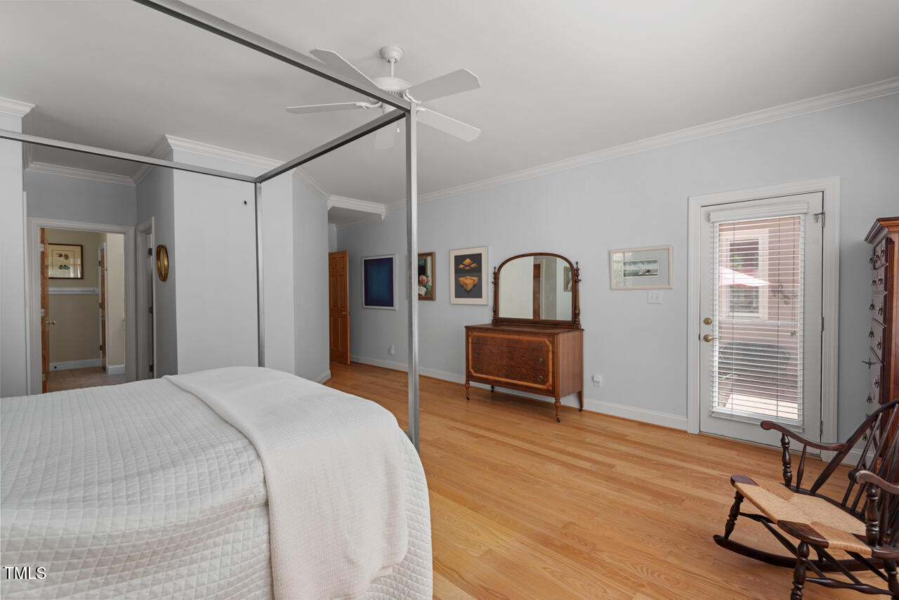 30119 Settle Chapel Hill, NC 27517 - Photo 35 of 49 a bedroom with a bed closet and a flat tv screen on the dresser