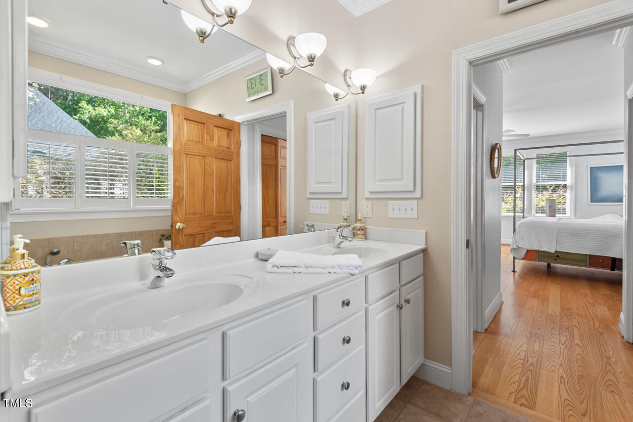 30119 Settle Chapel Hill, NC 27517 - Photo 37 of 49 a bathroom with a double vanity sink and a mirror