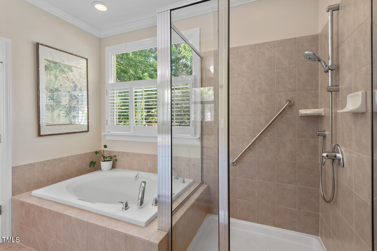 30119 Settle Chapel Hill, NC 27517 - Photo 38 of 49 a bathroom with a tub a window and a shower