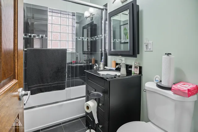 a bedroom with a bed and a flat tv screen