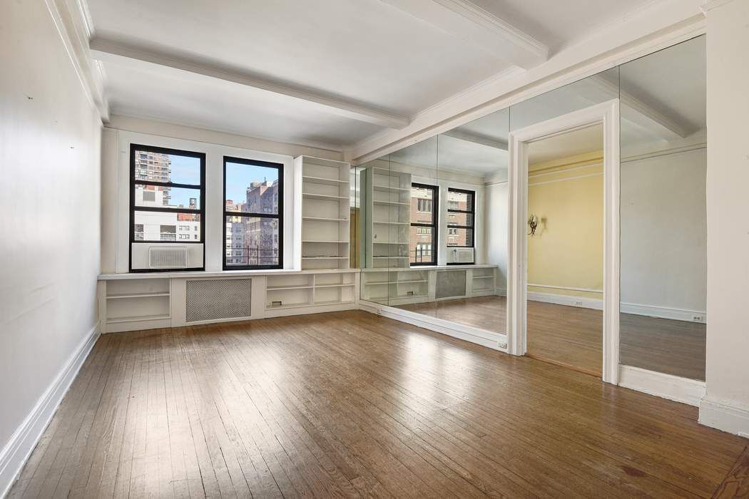 64 East 86th Street, Unit 11A Manhattan, NY 10028 - Photo 7 of 11 an empty room with wooden floor and windows
