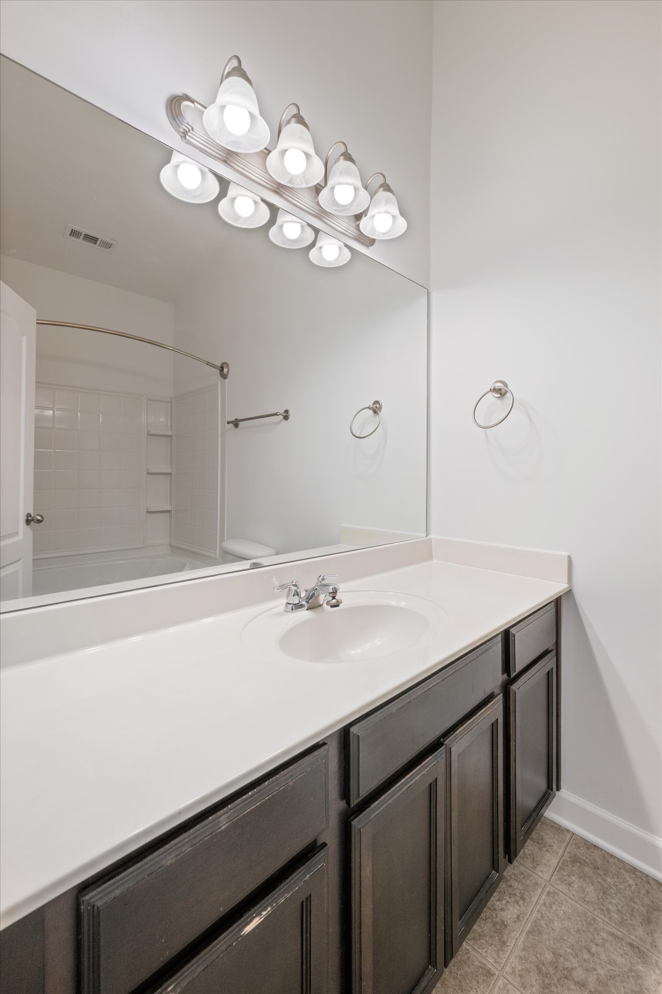 735 Tulip Grove Road, Unit 311 Hermitage, TN 37076 - Photo 16 of 22 a bathroom with a sink a light fixture and a mirror