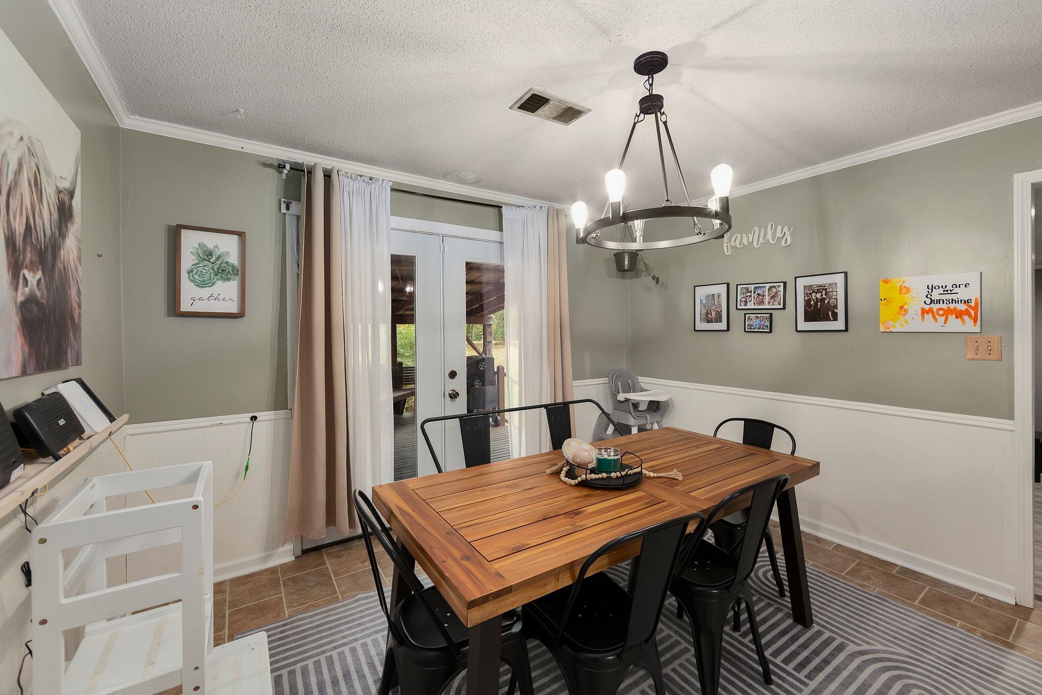 795 Burnett Mills Road Bolivar, TN 38008 - Photo 11 of 29 a view of a dining room with furniture window and wooden floor
