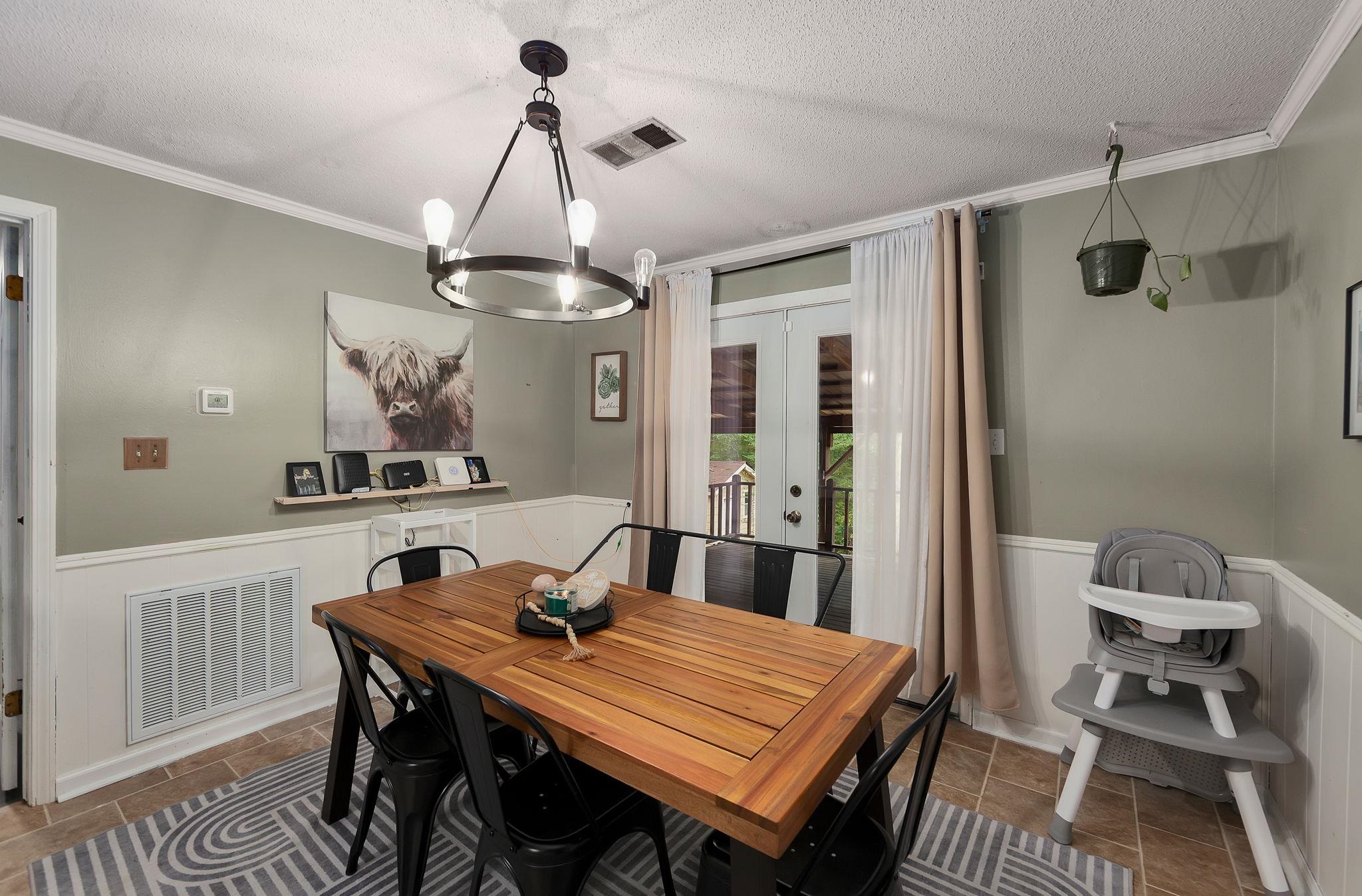 795 Burnett Mills Road Bolivar, TN 38008 - Photo 12 of 29 a view of a dining room with furniture window and wooden floor