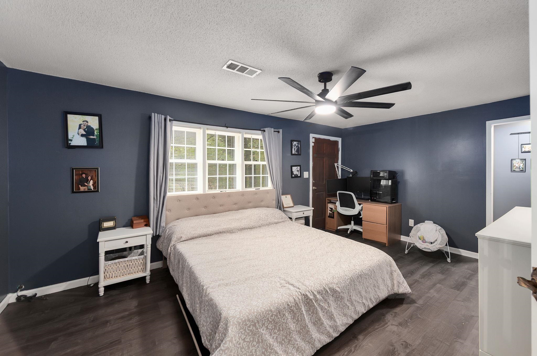 795 Burnett Mills Road Bolivar, TN 38008 - Photo 13 of 29 a bedroom with a large bed and a large window