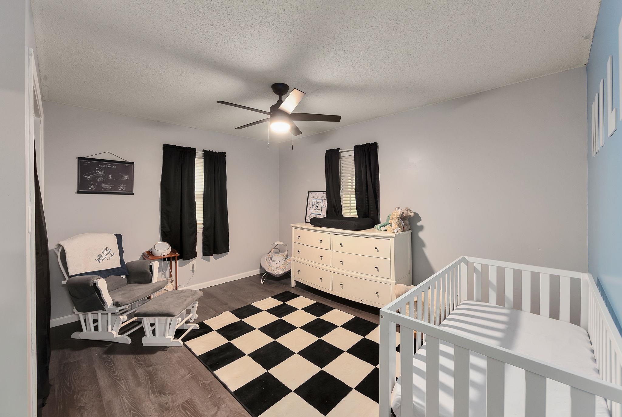 795 Burnett Mills Road Bolivar, TN 38008 - Photo 15 of 29 a bedroom with a bed and a chandelier