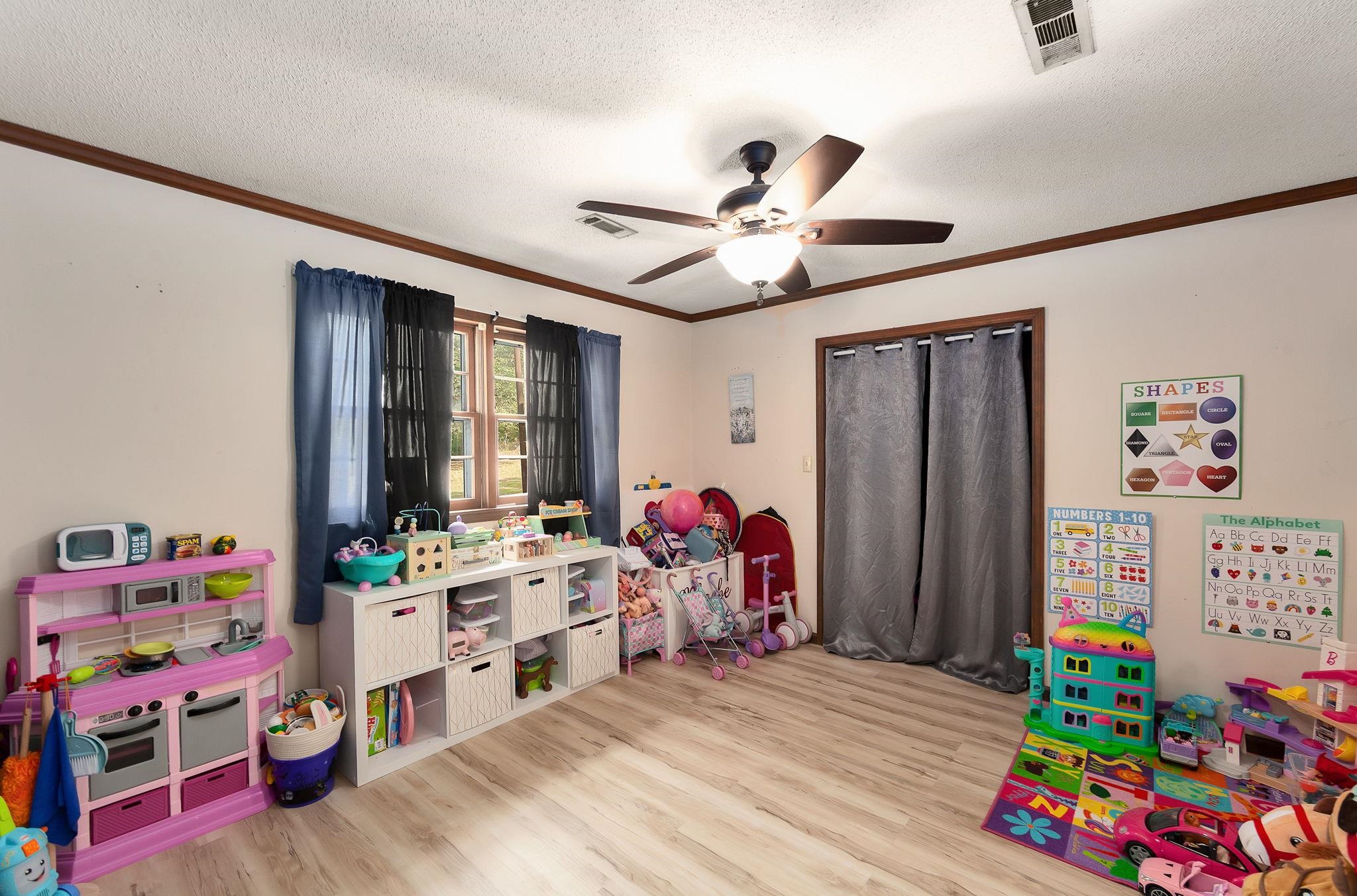 795 Burnett Mills Road Bolivar, TN 38008 - Photo 20 of 29 a living room with furniture a baby crib and a window