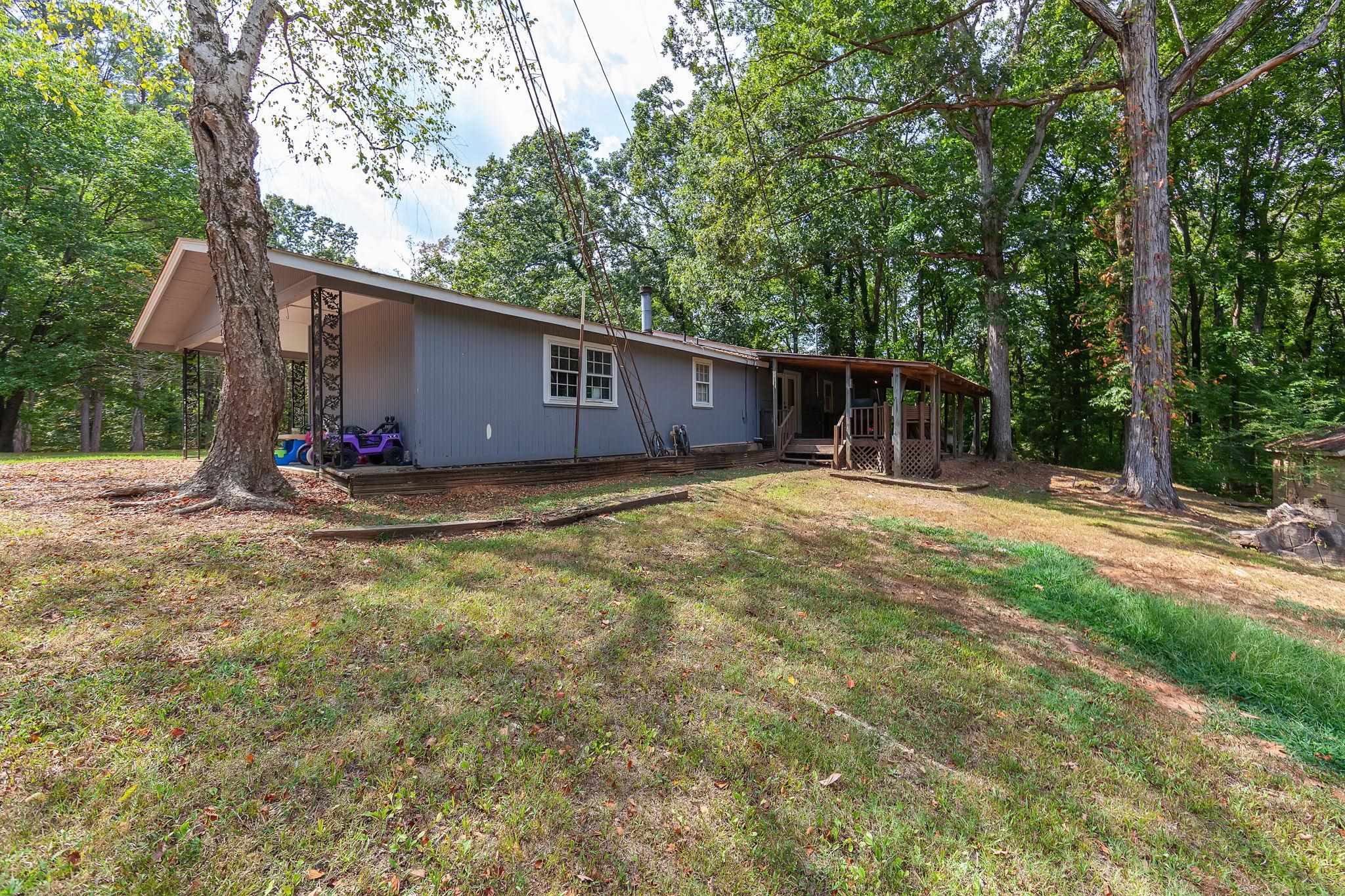795 Burnett Mills Road Bolivar, TN 38008 - Photo 22 of 29 a backyard of a house with table and chairs