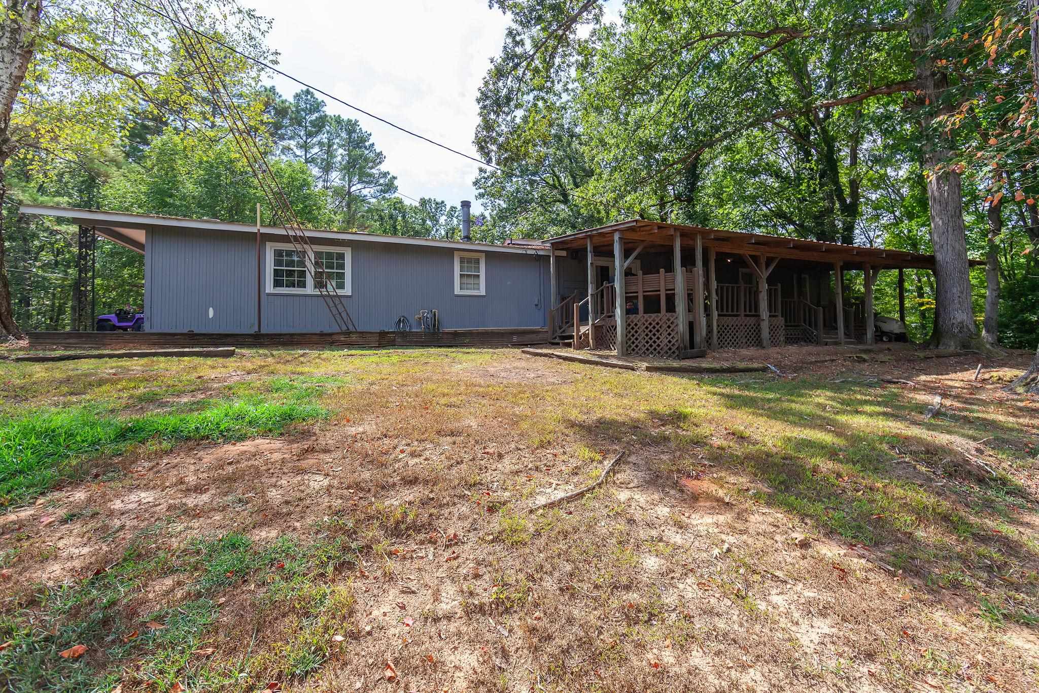 795 Burnett Mills Road Bolivar, TN 38008 - Photo 24 of 29 a backyard of a house with yard and garage