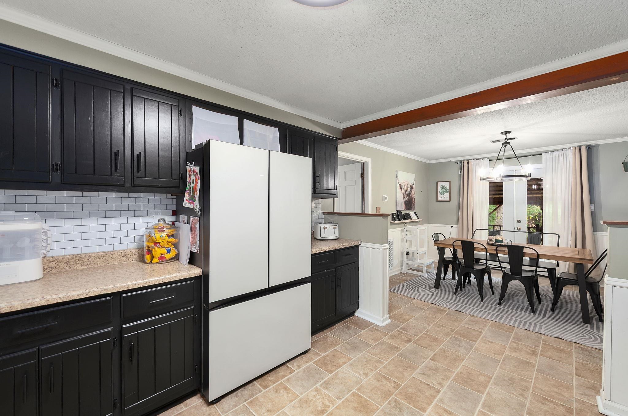 795 Burnett Mills Road Bolivar, TN 38008 - Photo 6 of 29 a kitchen with refrigerator cabinets and dining table