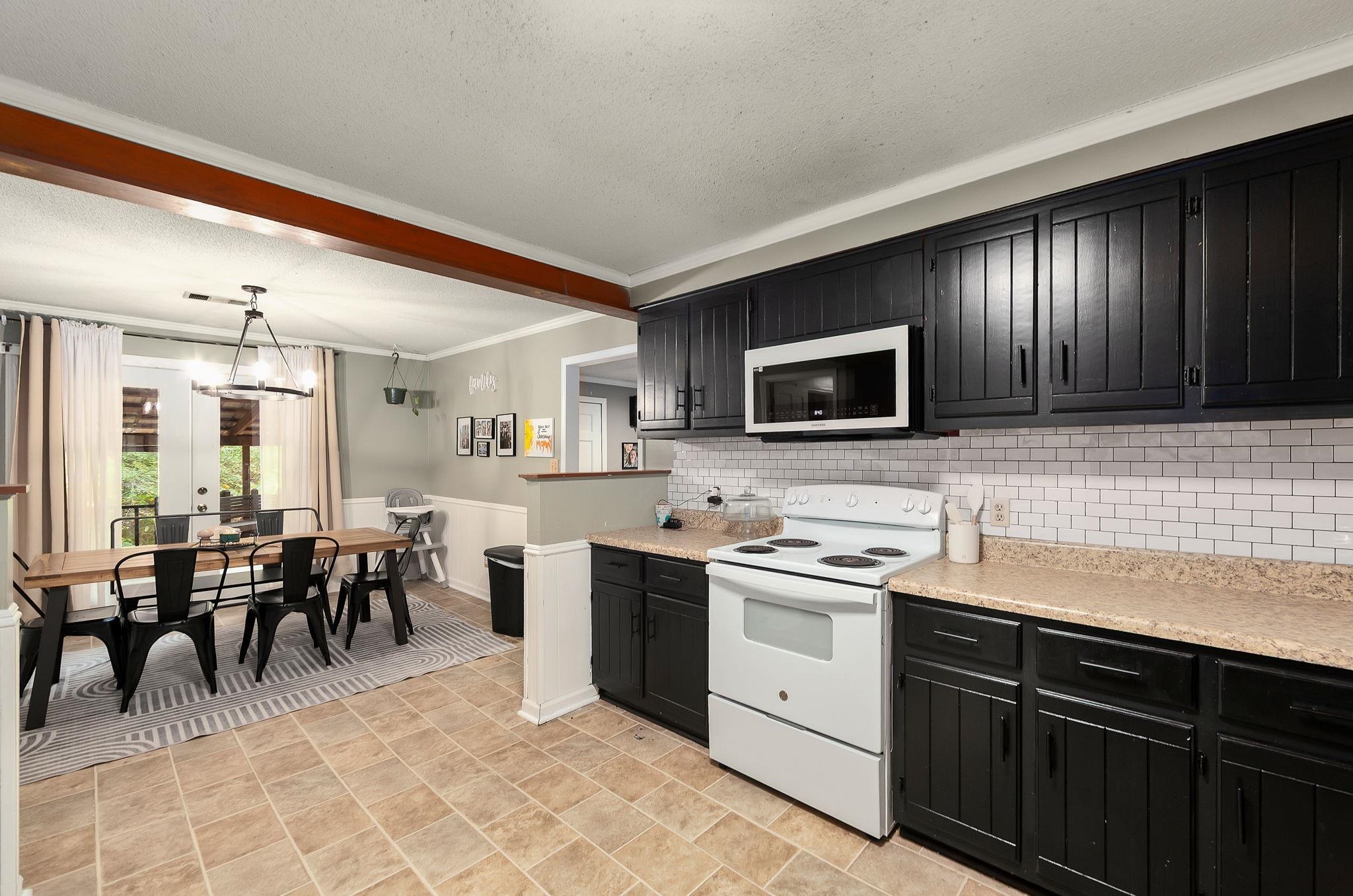 795 Burnett Mills Road Bolivar, TN 38008 - Photo 7 of 29 a kitchen with lots of counter top space appliances and cabinets