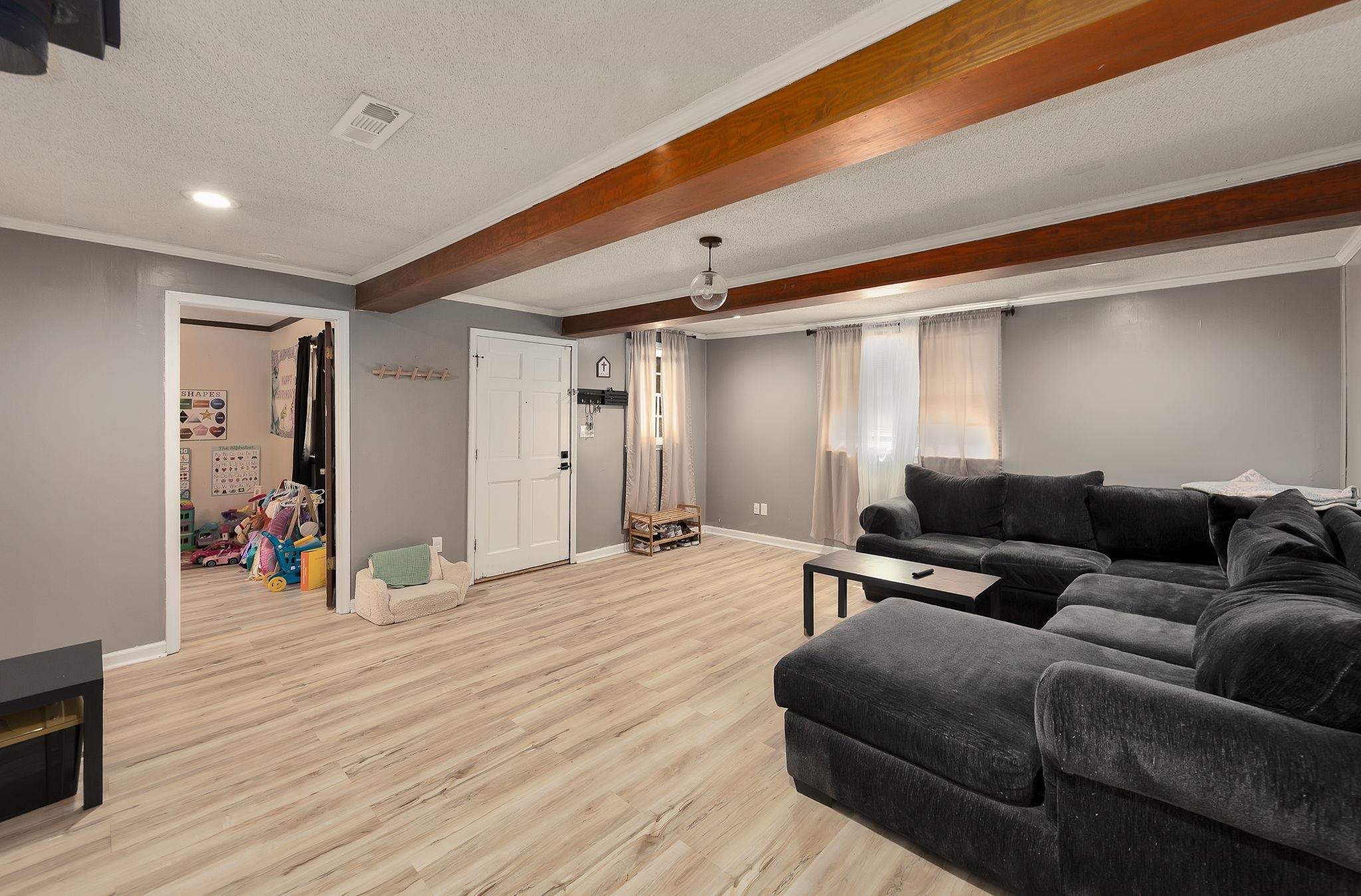 795 Burnett Mills Road Bolivar, TN 38008 - Photo 10 of 29 a living room with furniture and a wooden floor