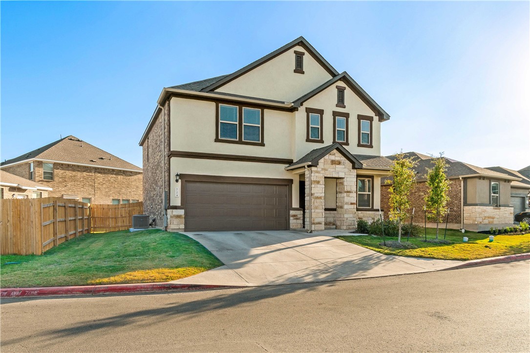 a view of a white house with a big yard and large trees