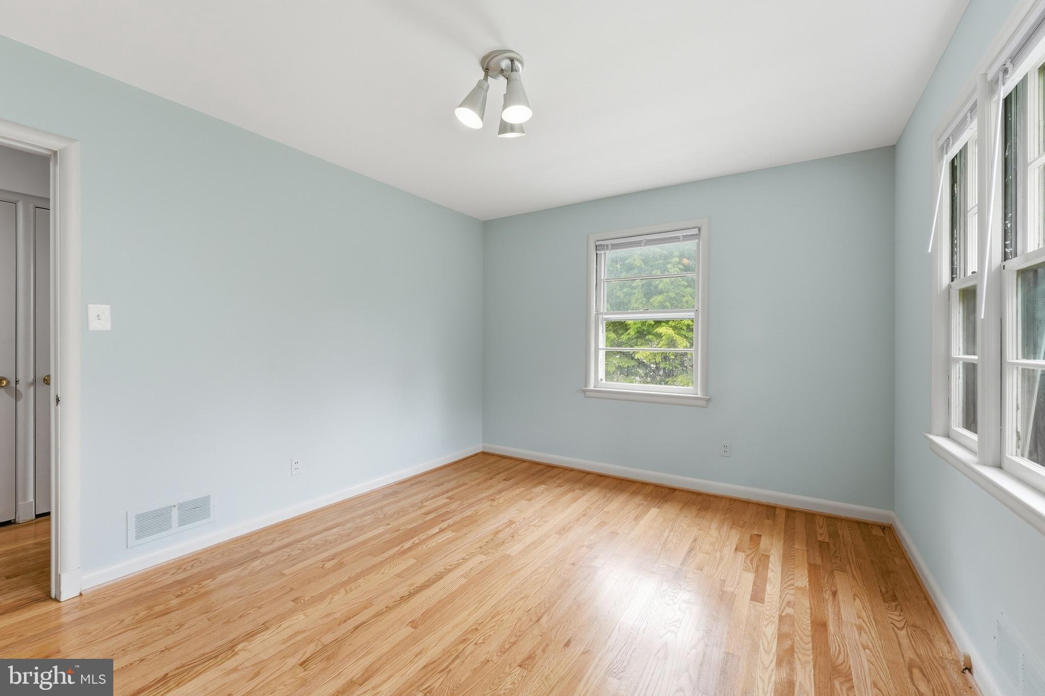 228 Northwest Terrace Silver Spring, MD 20901 - Photo 32 of 70 a view of an empty room with wooden floor and a window