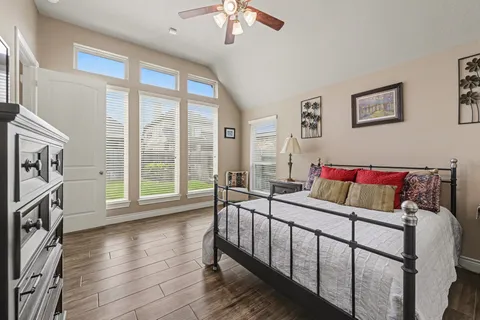 a bedroom with a bed and a large window
