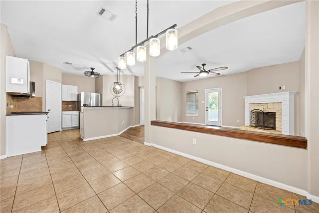 a view of a kitchen with cabinet and a fireplace