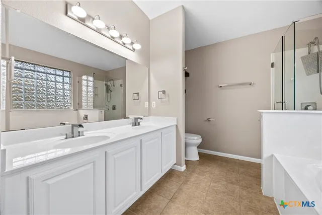a bathroom with a double vanity sink and a mirror