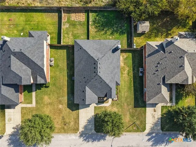 an aerial view of a house with a garden and pool