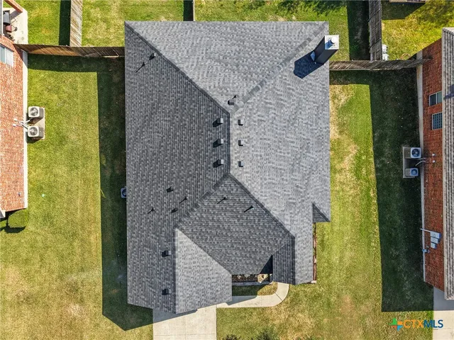 an aerial view of residential houses with outdoor space and swimming pool