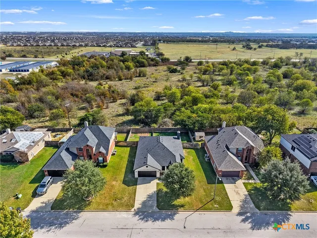 an aerial view of residential houses with outdoor space
