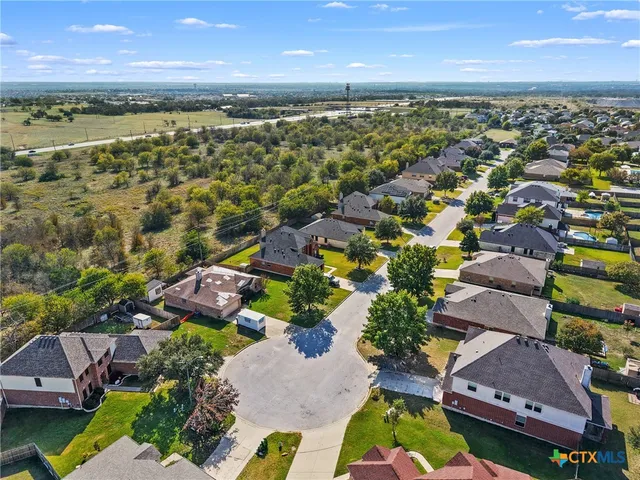 an aerial view of residential houses with outdoor space